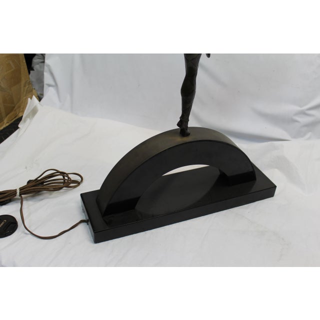 A well known Figurine made into a Lamp . Cast in lost wax Bronze and with multi-patina finish . Small lanterns hanging...