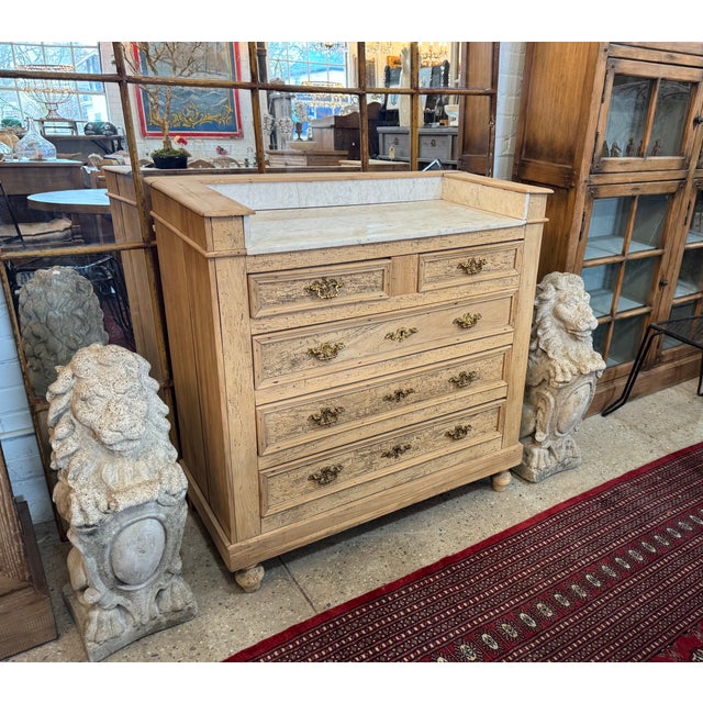 A quintessential example of French craftsmanship from the turn of the century, this antique chest features a beautiful...