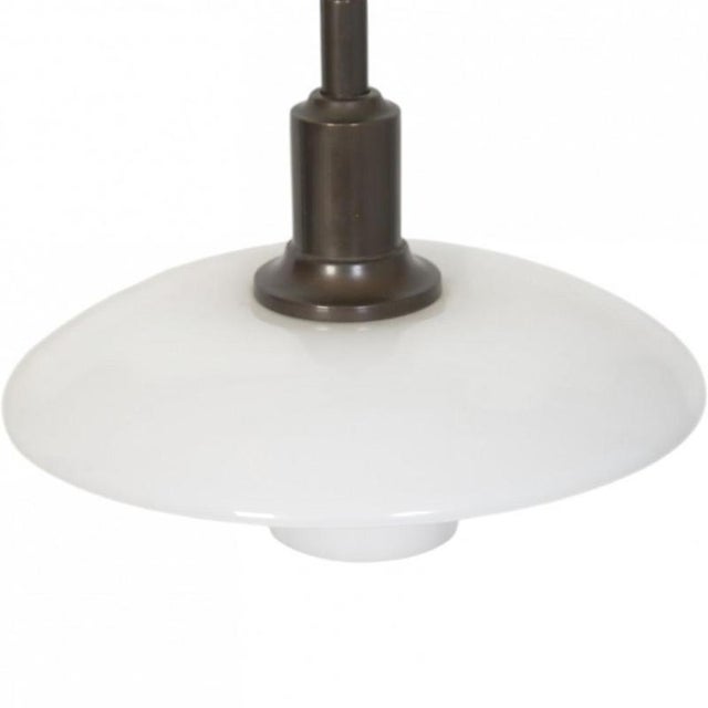 Poul Henningsen 100 year Anniversary edition of the TrePh 3/2 pendant lamp, with a fitting of browned brass and shades of...