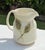 Pretty vintage ceramic pitcher dating to 1994, featuring a softly sculptural form with an organically shaped handle and...
