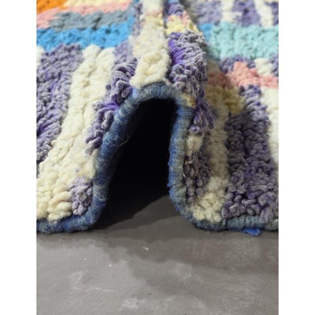 Boujad Rug | Handwoven Berber Wool Rug with Periwinkle Field and Skyline Motif This striking Boujad rug features a...