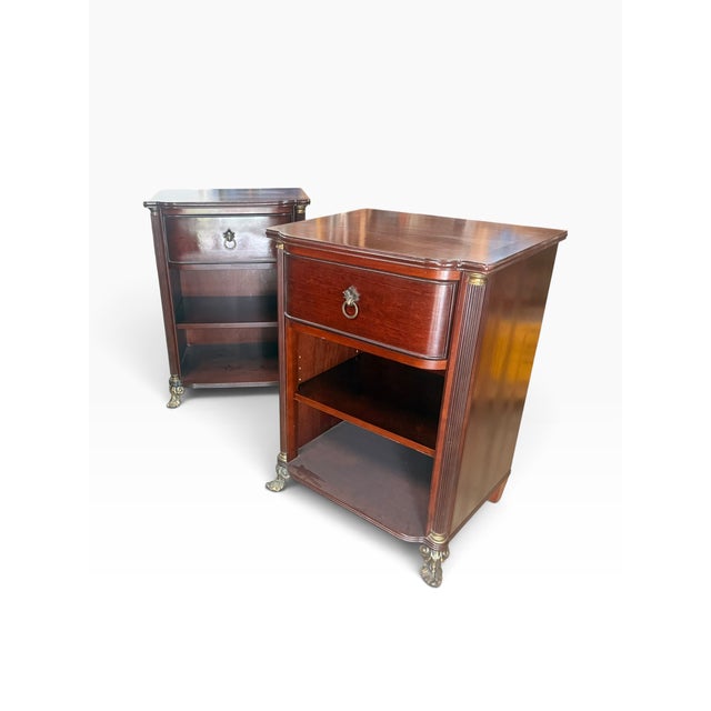 A handsome pair of Bombay Company nightstands, dating to 2002, featuring an elegant Neoclassical and Empire Revival-...