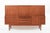 This vintage mid-century Danish modern tall teak wood sideboard server or bar cabinet attributed to Johannes Andersen for...
