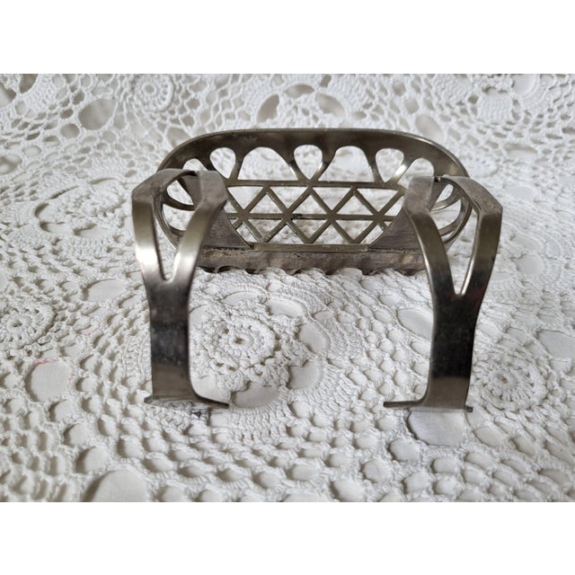 An antique soap holder dish with hook. Meant for a clawfoot bathtub and from the early 1900s. It is very heavy and...