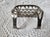 An antique soap holder dish with hook. Meant for a clawfoot bathtub and from the early 1900s. It is very heavy and...