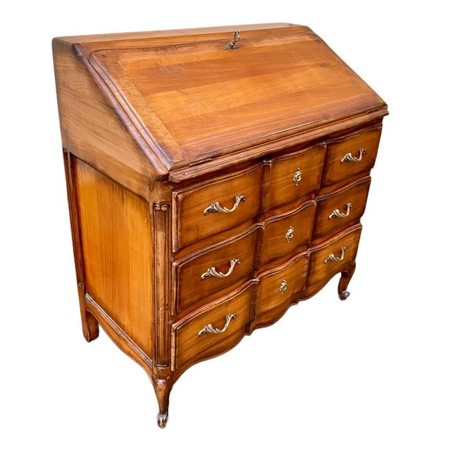 Louis XV style secretary desk, also known as a "Scriban," crafted from fruitwood, with a drop-front revealing two drawers...