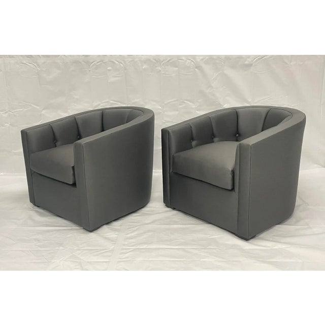 A refined pair of American-made transitional modern lounge chairs, custom-upholstered in charcoal gray performance fabric....