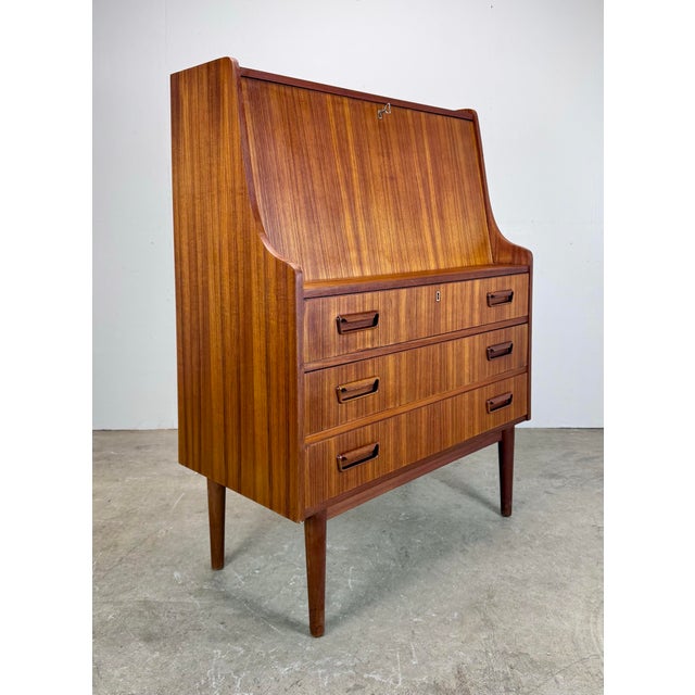 A teak secretary desk/chest made in Denmark and sold by retailer Maurice Villency, circa 1960’s. Attributed to designer...