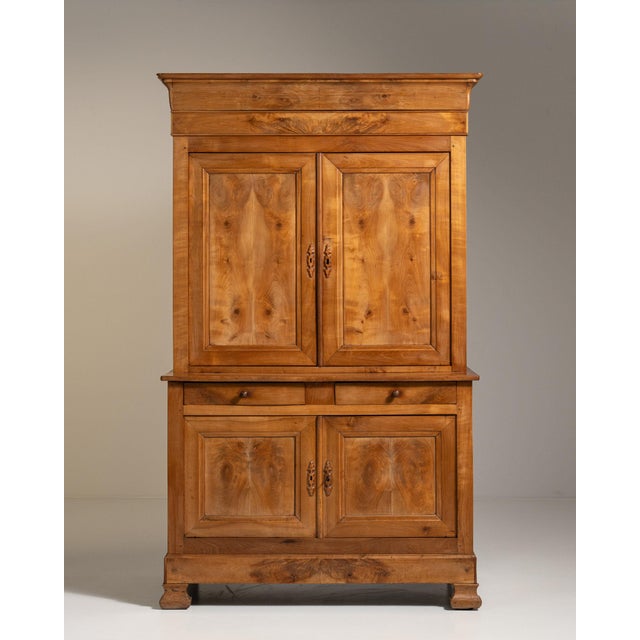 Carved oak two-part cabinet in Warm Honey Oak. The warm honey oak surface highlights burl-veneered door panels, molded...