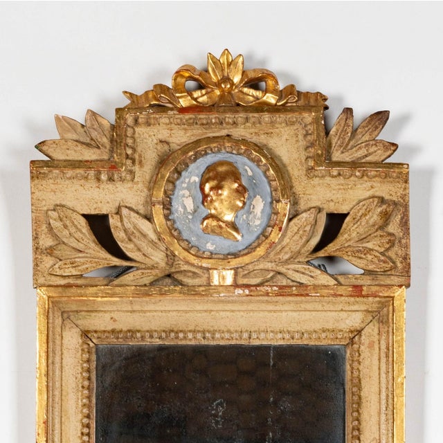 A lovely Gustavian Swedish Gilt cameo mirror with its original glass mirror. The mirror has an added 20th Century sconce...