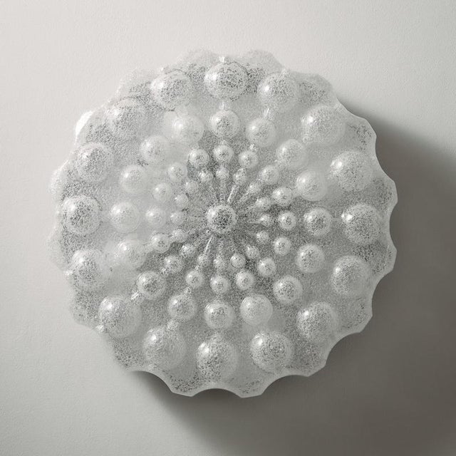 Metal and plastic wall lamp with organic shapes from the 1970s. The ceiling lamp has beautifully rounded, curved shapes...