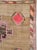 This Mid-20th century Turkish Anatolian room-size carpet presents a bold, graphic composition arranged across a warm...