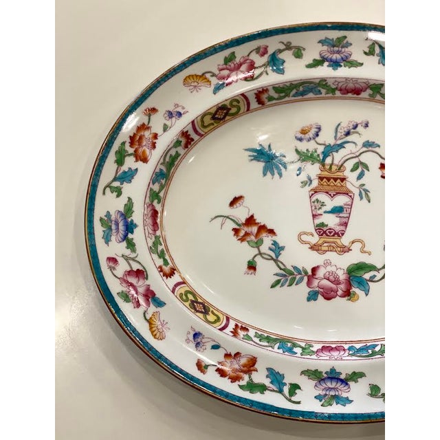 This vintage serving platter is made of porcelain and features a beautiful overall floral pattern. The colors in this...
