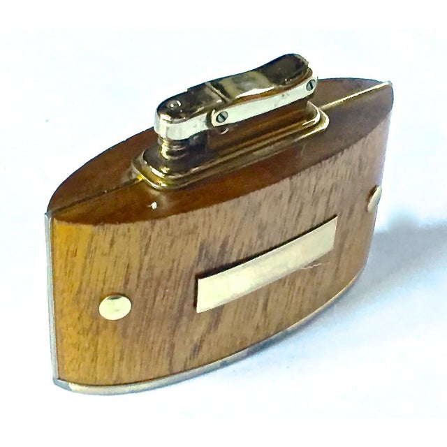Mid-Century Modern wood and brass cigarette lighter. With brass plaque on the front. Brass igniter and walnut body. Marked...