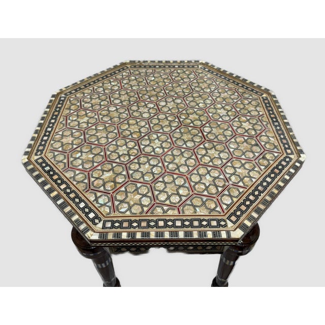 Elevate your space with this handmade round side table crafted from solid wood and fully inlaid with natural mother of...