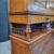 This Charming oak Arts & Crafts bureau cabinet/student desk is in the style of James Shoolbred & Co. The galleried shaped...