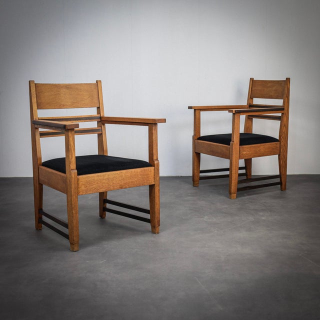 A striking pair of art deco armchairs from the 1930s, attributed to lov oosterbeek. The chairs combine strong lines with...