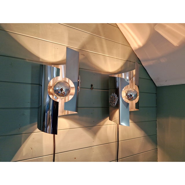 Pair of Space Age chrome wall sconces, 1970s. They have been rewired and are compatible with an E27 LED bulb. The chrome...