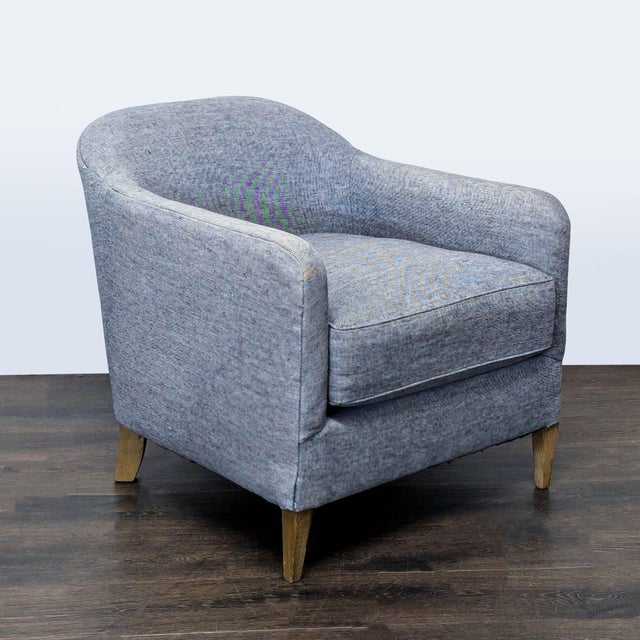 This stylish lounge chair from Restoration Hardware features a comfortable, curved backrest and soft blue upholstery. The...