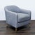 This stylish lounge chair from Restoration Hardware features a comfortable, curved backrest and soft blue upholstery. The...