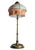 An Art Nouveau Art Deco brass faux bamboo table lamp featuring a stained glass style shade. This antique lamp features a...