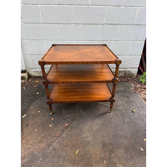Vintage English Regency-style three-tier etagere or side table by Weiman It features turned corner supports, brass...