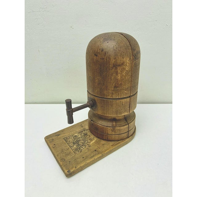 An original french wooden hat tensioner with iron screw mechanism dating from the early 20th century. it consists of two...