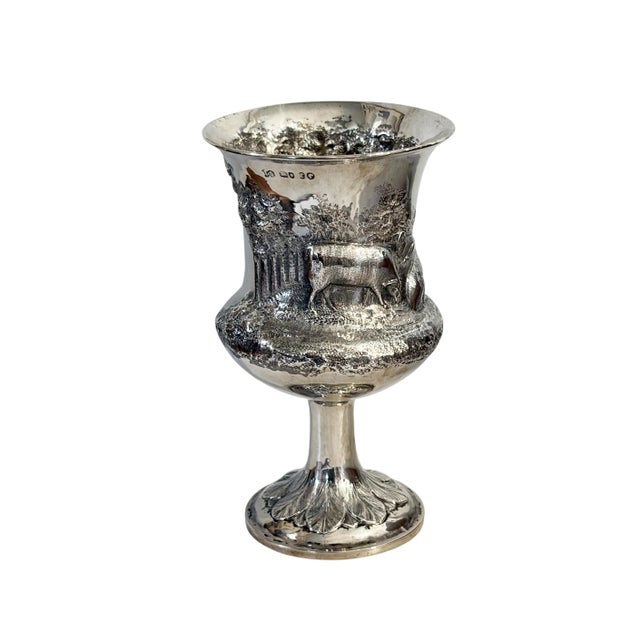 Antique English sterling silver goblet showcasing exceptional craftsmanship with high-relief repoussé pastoral scenes...