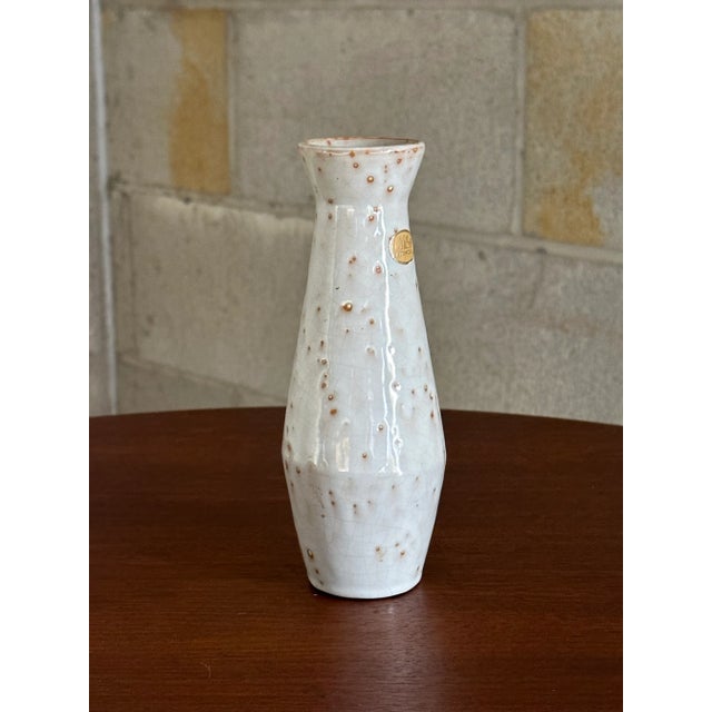 Timeless vase designed by Jerk Werkmäster and produced by Nittsjö. Features an off white grayish body with hints of rust...