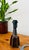 Ceramic table lamp with a hexagonal base, decorated with blue and brown glazed tones and featuring an unglazed neck....