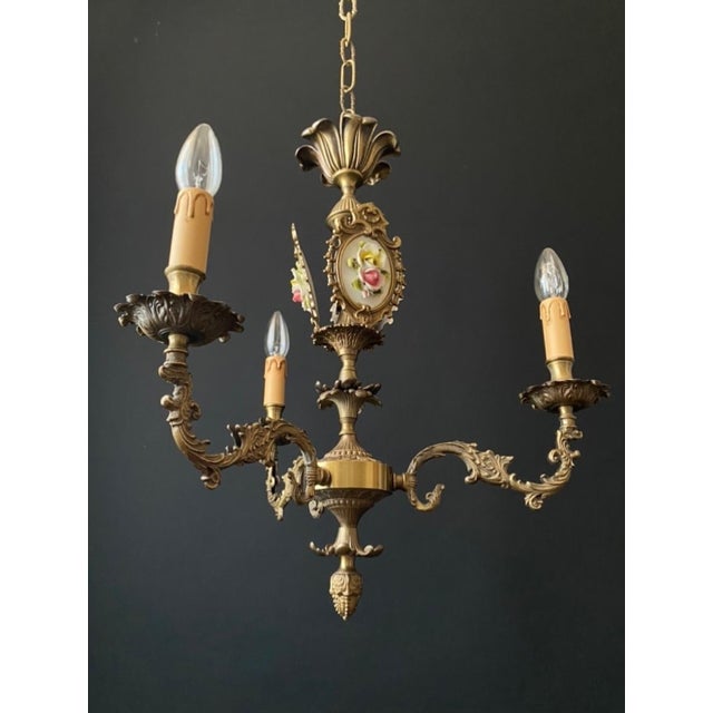 A magnificent antique chandelier. Italy, early 20th century. The chandelier is made of brass and bronze. Impeccable...