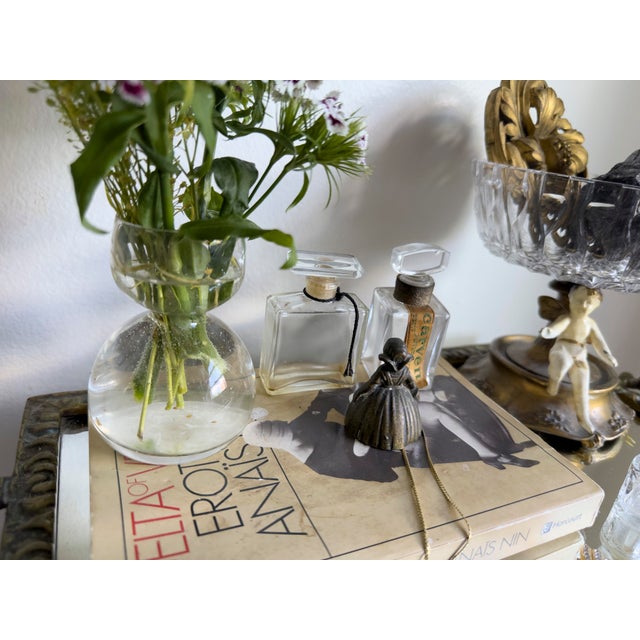 Vintage figural table bell in the form of a Dutch girl, cast in solid brass or bronze. The figure is modeled in...