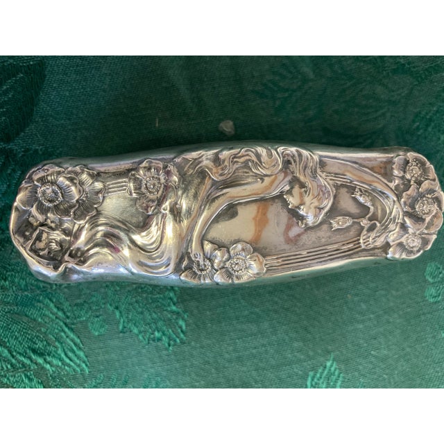 This a beautiful sterling silver clothes brush circa 1900-1920s that still contains the original brush bristles. The...