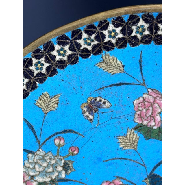 A bronze and cloisonné enamel round plate designed in Japan at the end of the 19th century, during the 'Meiji' era, which...