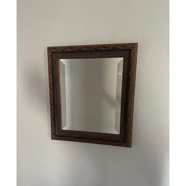 This ornately framed beveled glass mirror is from the 1960s or 1970s. Its frame is made of a heavy composite material that...