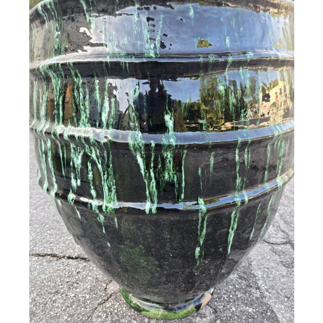 Make a dramatic statement with this handcrafted Moroccan pottery urn, featuring a rich deep-green glaze accented by...