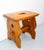French cabin stool tinted with a cherry wood color, a heart shape cut out of the top and check shapes on the sides. Good...