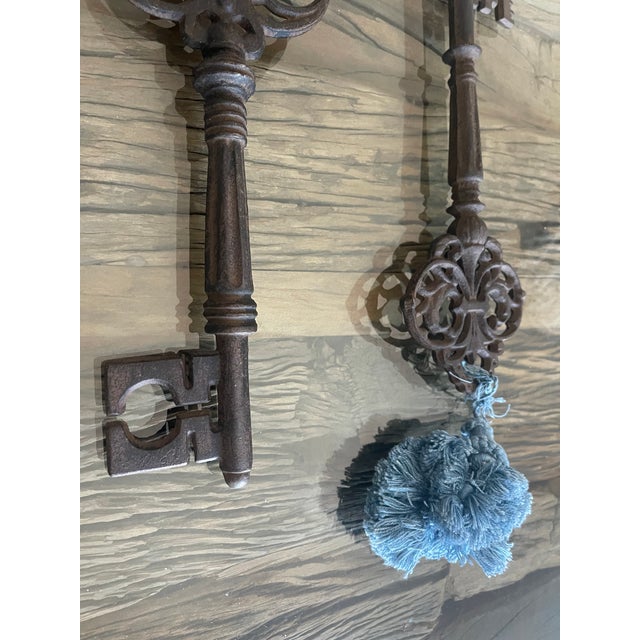 12” large vintage cast iron large keys with tassels. Great collectors items or home decor. Neobaroque style.