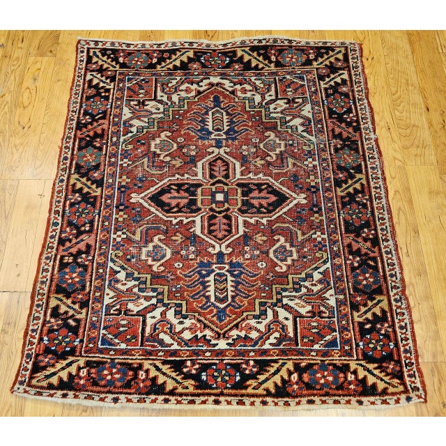 "A truly exceptional and rare example of Persian weaving, this hand-knotted Heriz Serapi rug from the first quarter of the...