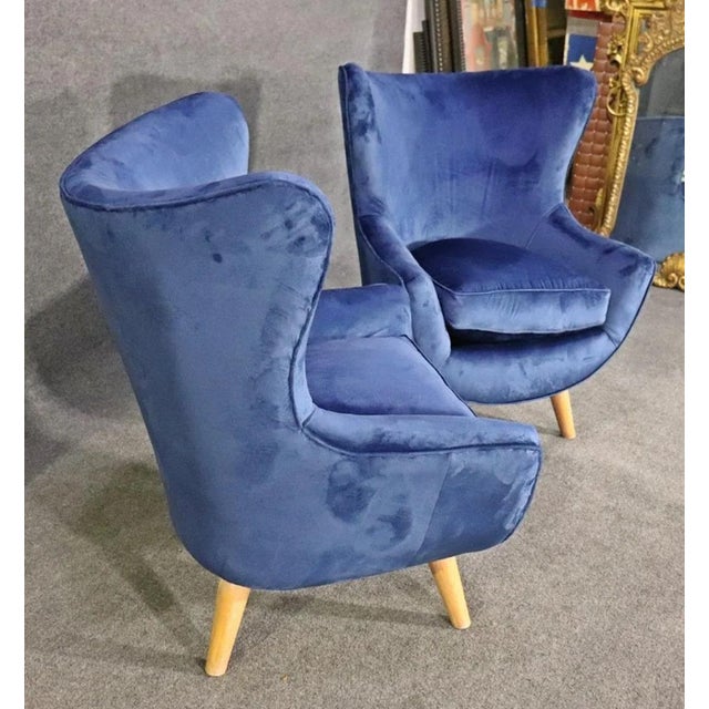 Unique modern style lounge chairs with cone legs. Soft velvet upholstery with wing back style.