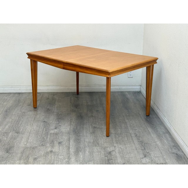 Mid century modern dining table manufactured by Heywood Wakefield includes one leaf extension, professionally restored.