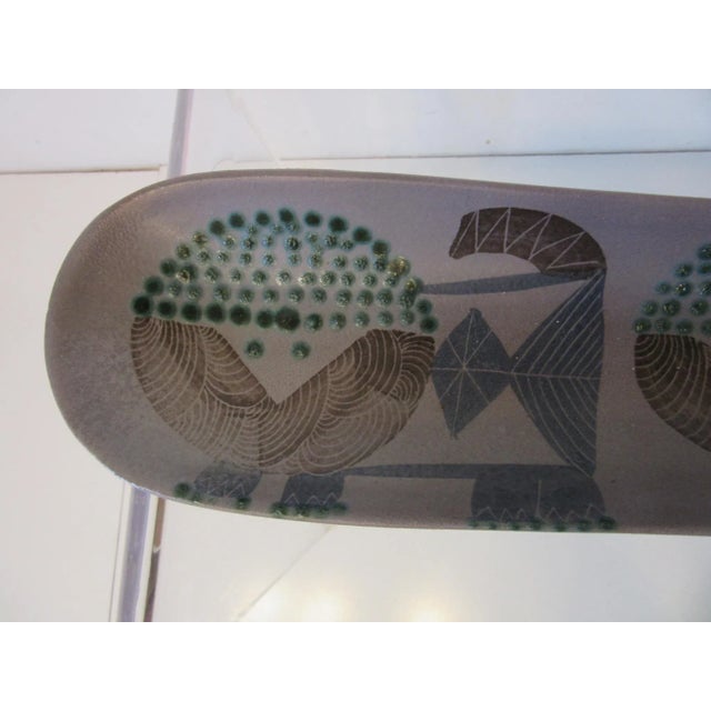 An early Harris G. Strong pottery fish tray or serving dish with glazed hand painted lions or animal forms to the surface....