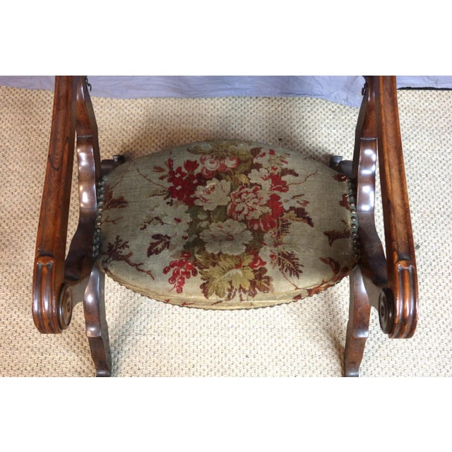 Napoleon III curule chair upholstered in antique velvet. This chair has the unique feature of transforming into a prie-...