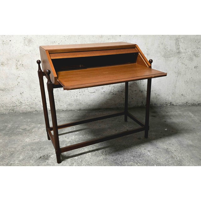 A 1960s proserpio brothers drop-leaf desk. An elegant and modern design in solid wood. The rolling top, or drop-leaf,...