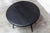Ercol coffee table, 1960s model 308, with a matte black half-moon top. Diameter 61cm. Designed by Lucian Ercolani, this...