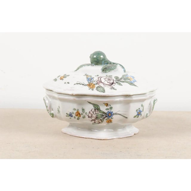 A French faïence mid-18th century oval-shaped soup tureen from Bordeaux with floral decor. Created in Southwestern France...