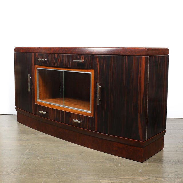 This elegant Art Deco Rosewood, Burled Carpathian Elm & Acacia Burl with Nickled Bronze Pulls Sideboard originates from...