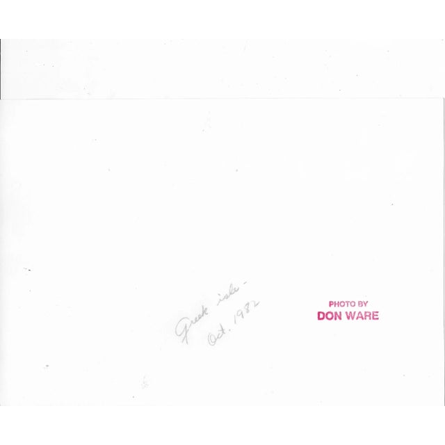 1982 photo of tourists on an island in Greece by Los Angeles, California photographer Don Ware (1921-2006). Titled, dated...