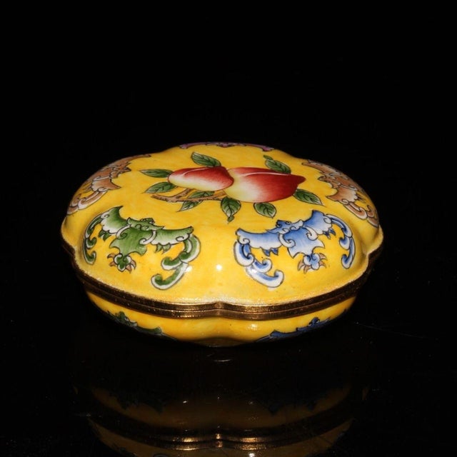 A lovely handcrafted lidded box made on a red copper base, decorated with traditional Chinese painted enamel artwork. The...