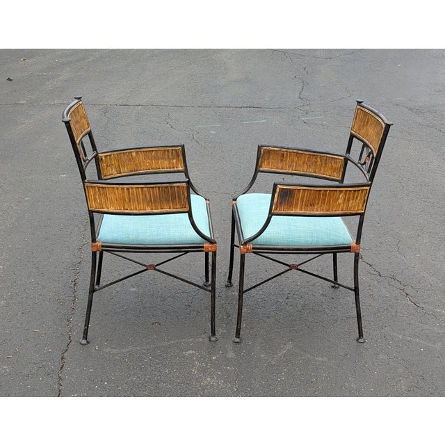 This elegant pair of armchairs masterfully blends organic warmth with industrial refinement. Featuring a metal frame set...